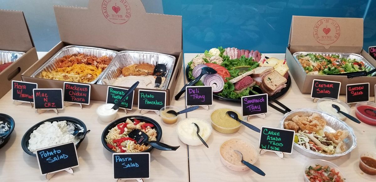 Full catering spread with labeled dishes
