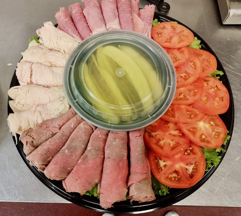 Deli meat platter with tomato and pickles