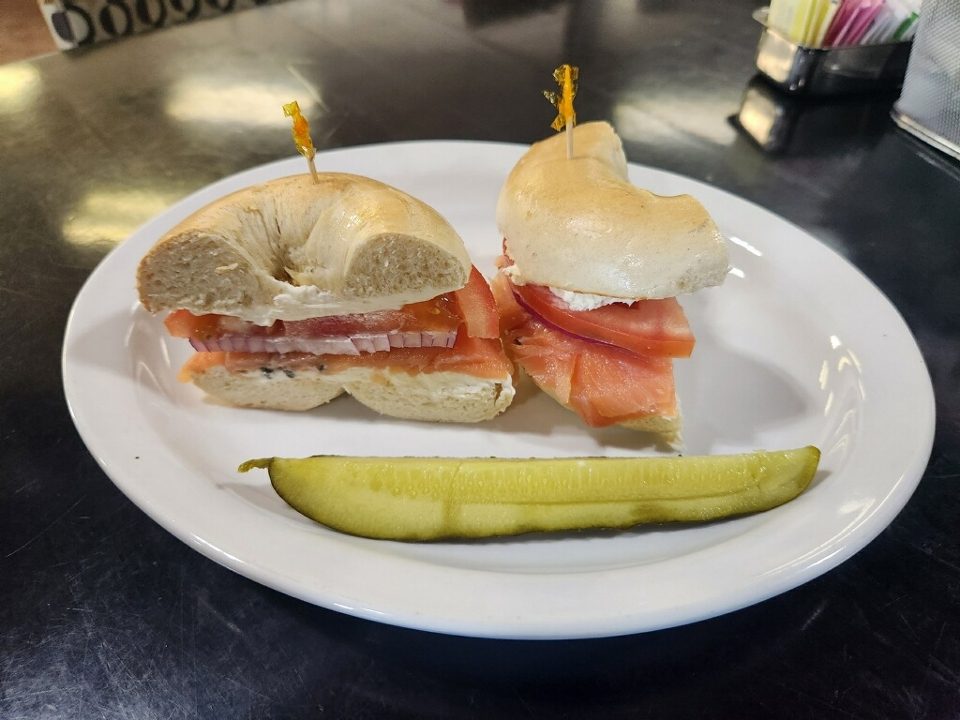 Lox bagel sandwiches with a pickle spear