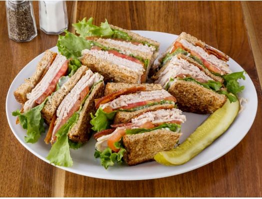 Triple decker club sandwiches with a pickle