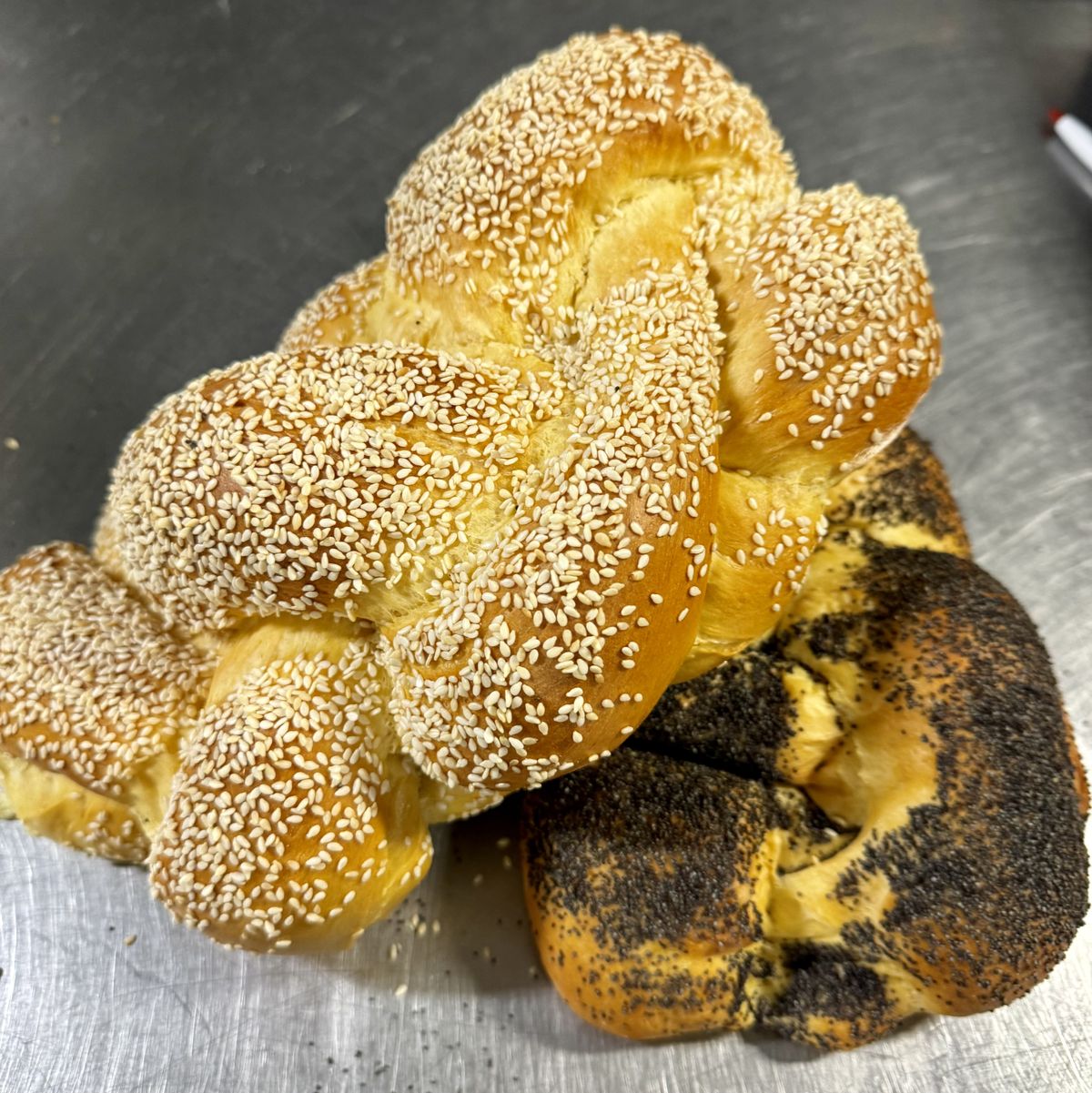Braided challahs with sesame and poppy seeds