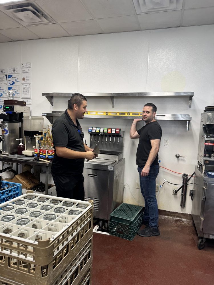 Two NYBB team members at the drink station
