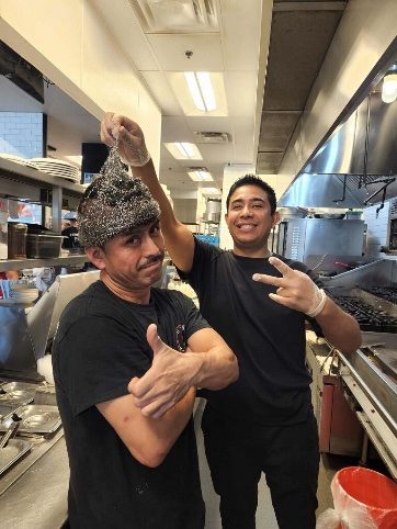 Two NYBB team members joking around in the kitchen