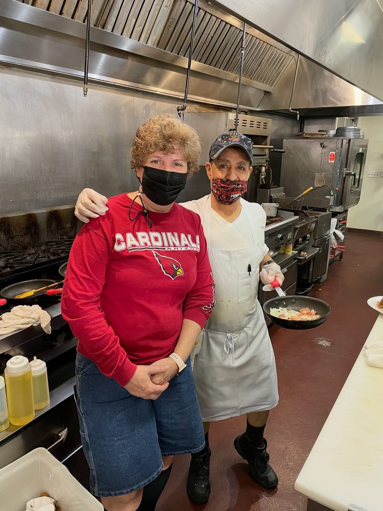 Two NYBB kitchen team members smiling in the kitchen