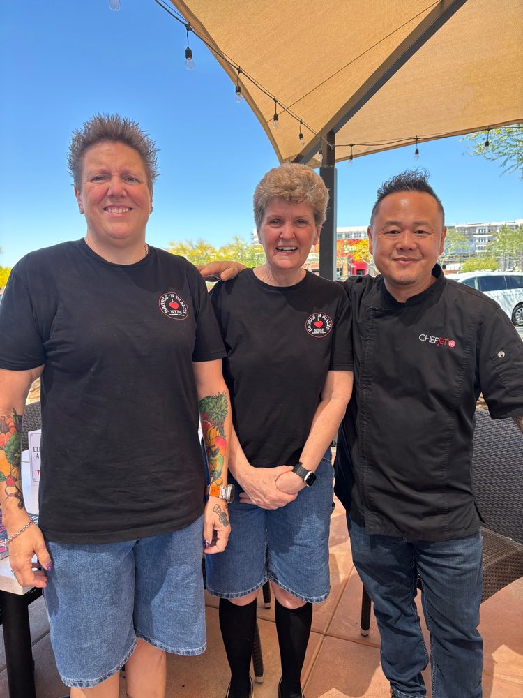 Shelley, Ruth Leatherman, and Chef Jet posing on the patio
